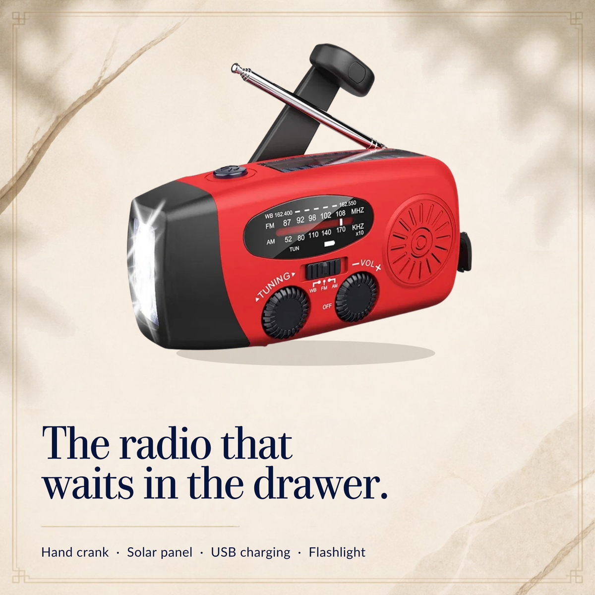 Red hand-crank emergency radio with the crank up, antenna raised and flashlight on