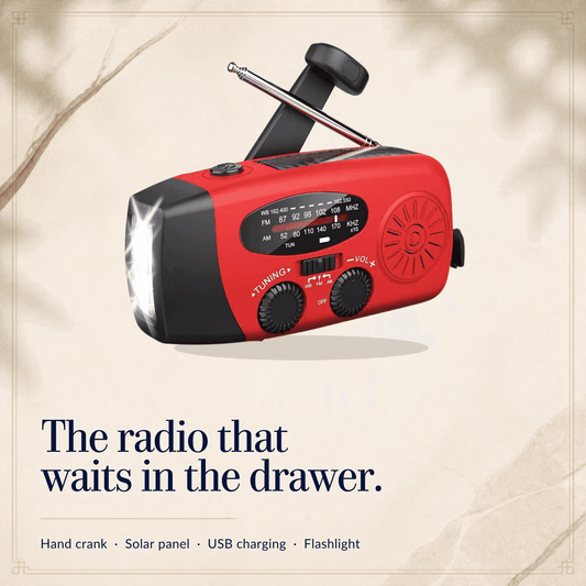 Red hand-crank emergency radio with the crank up, antenna raised and flashlight on